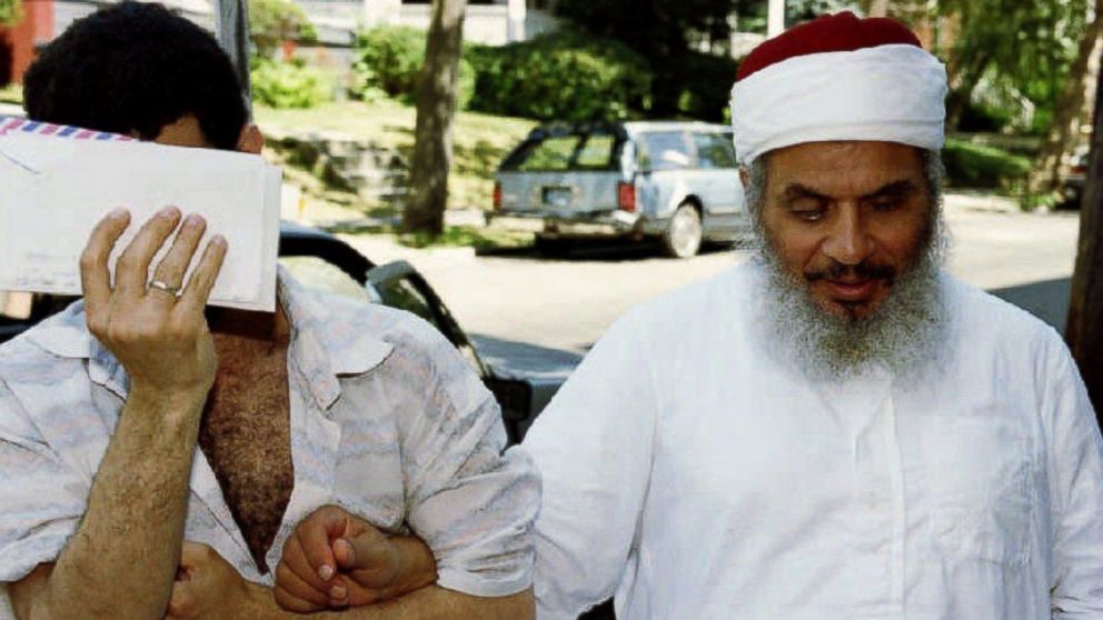 Sheik Omar Abdel-Rahman (R) entering his apartment building with an unidentified man (L) after afternoon prayers at his mosque in Jersey City, New Jersey, June 25, 1993. 
