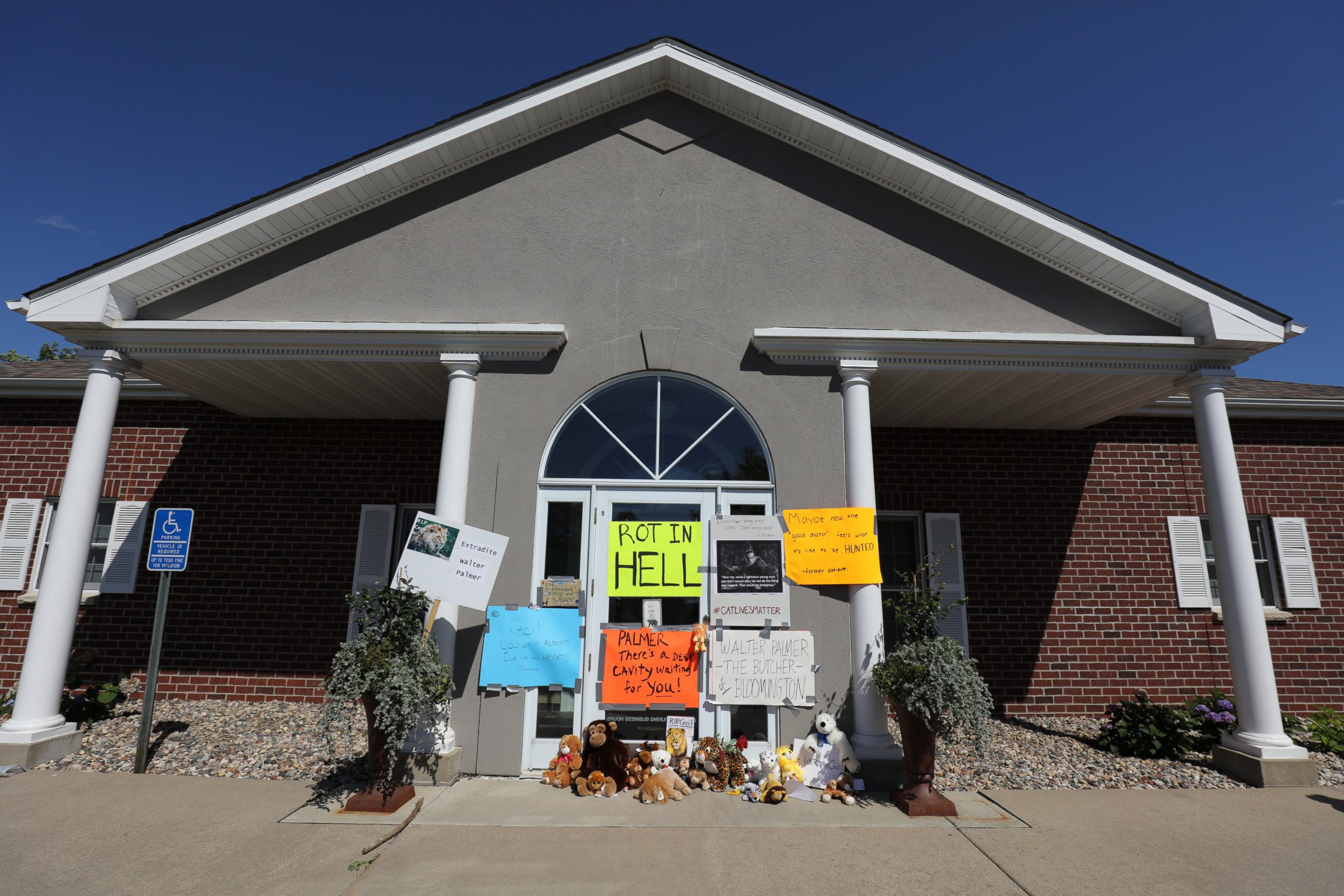 PHOTO: Protesters place signs on the doors of  Dr. Walter Palmer's River Bluff Dental Clinic to call attention to the alleged poaching of Cecil the lion on July 29, 2015 in Bloomington, Minn.