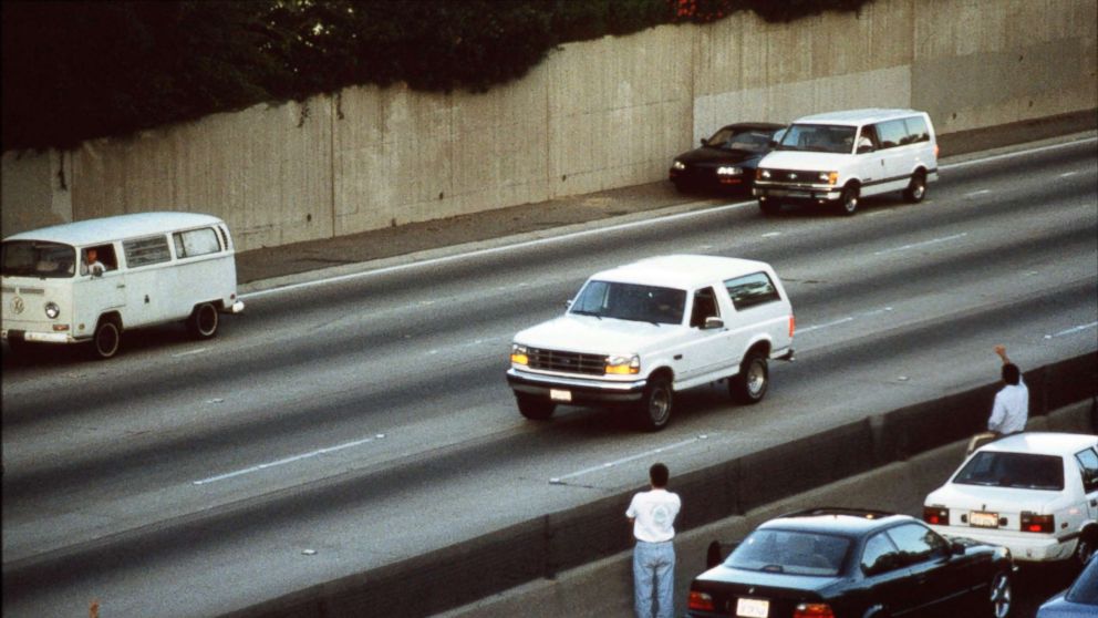 PHOTO: Motorists wave as police cars pursue the Ford Bronco carrying fugitive murder suspect O.J. Simpson on a 90-minute slow-speed car chase June 17, 1994 on the 405 freeway in Los Angeles, Calif.