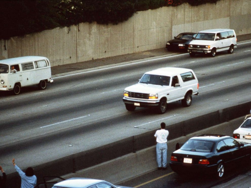 PHOTO: Motorists wave as police cars pursue the Ford Bronco carrying fugitive murder suspect O.J. Simpson on a 90-minute slow-speed car chase June 17, 1994 on the 405 freeway in Los Angeles, Calif.