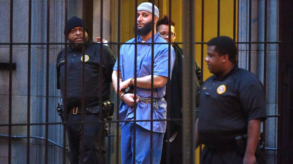 Officials escort "Serial" podcast subject Adnan Syed from the courthouse following the completion of the first day of hearings for a retrial in Baltimore on Feb. 3, 2016.
