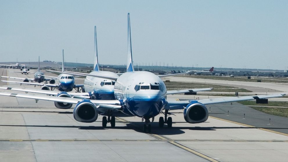 A file photo of airplanes in a row on a runway.