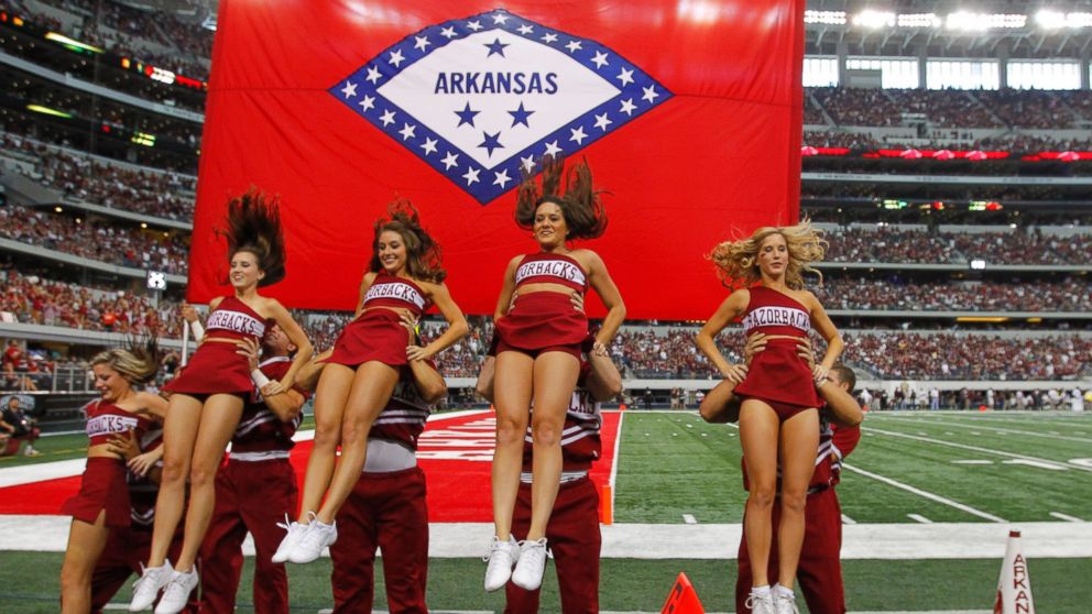 PHOTO: Arkansas cheerleaders perform a routine in front of their state flag at Cowboys Stadium in Arlington, Texas, on Oct. 1, 2011.