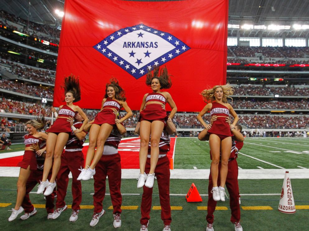 PHOTO: Arkansas cheerleaders perform a routine in front of their state flag at Cowboys Stadium in Arlington, Texas, on Oct. 1, 2011.