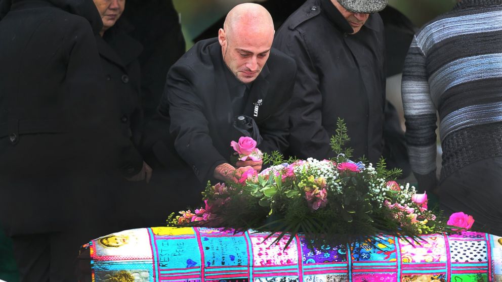 Joseph Amoroso, Bella Bond's biological father, wept as he took a pink rose from her coffin on Nov. 28, 2015, in Winthrop, Mass.