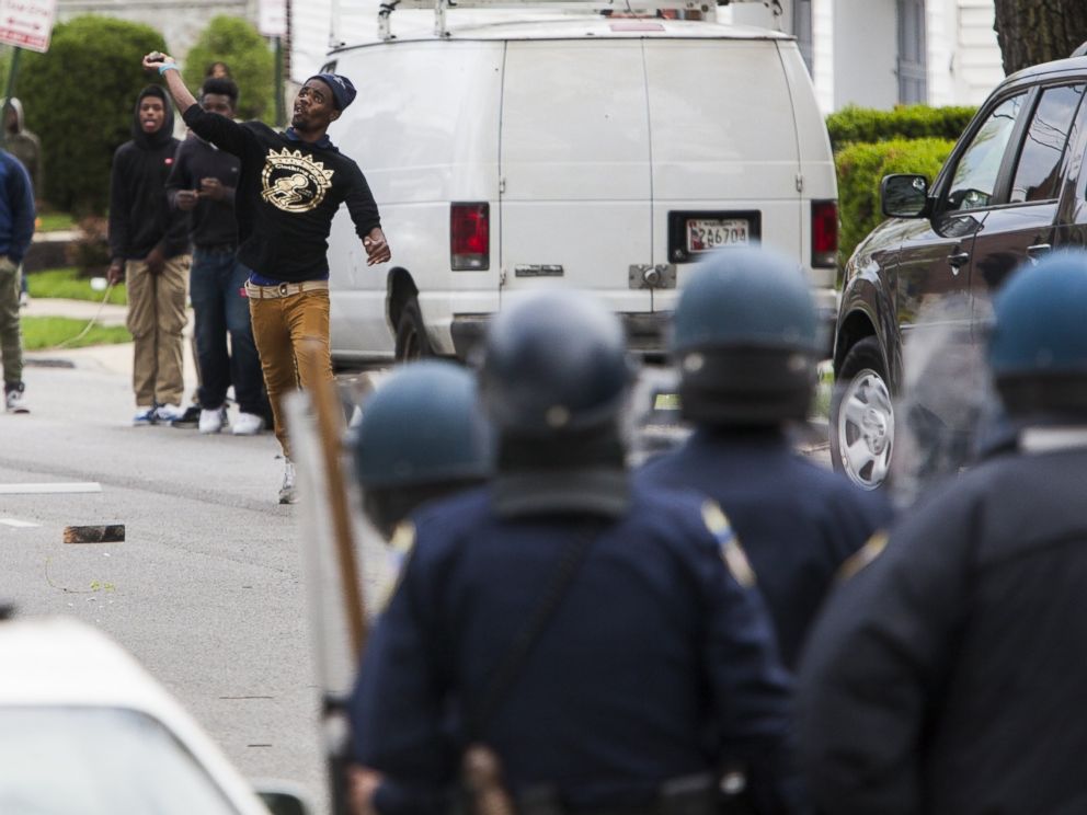 PHOTO: A protester throws a rock at police during riots in Baltimore, USA on April 27, 2015.