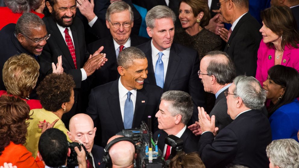 President Barack Obama greets members of Congress as he arrives in the House chamber in the U.S. Capitol to deliver his State of the Union address on Jan. 20, 2015.