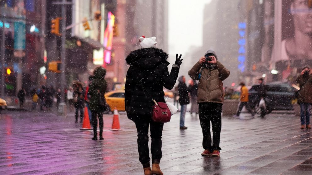 A tourist has her picture taken during a snow storm in New York's Times Square, Jan. 26, 2015. Thousands of flights were canceled as millions of Americans in the Northeast braced for a winter storm that New York's mayor warned could be one of the biggest blizzards in history.