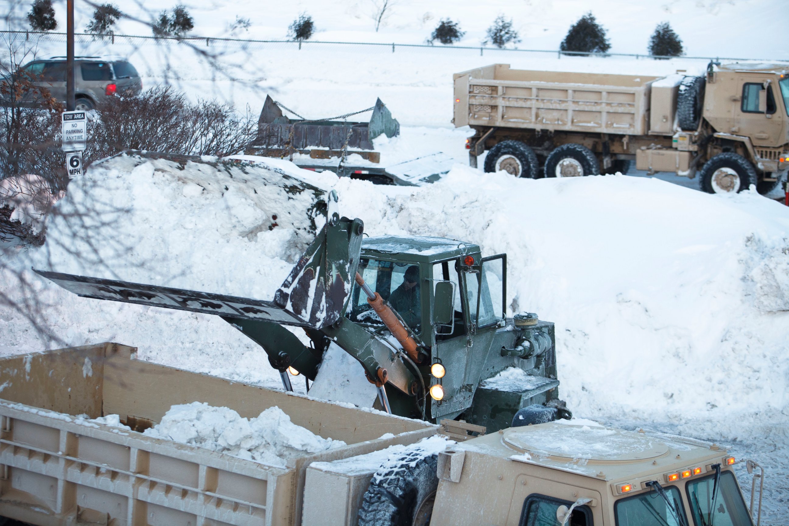 PHOTO: Four units from the Maine National Guard worked with heavy equipment to remove snow from the Braintree MBTA T station on Ivory Street, Feb. 15, 2015.