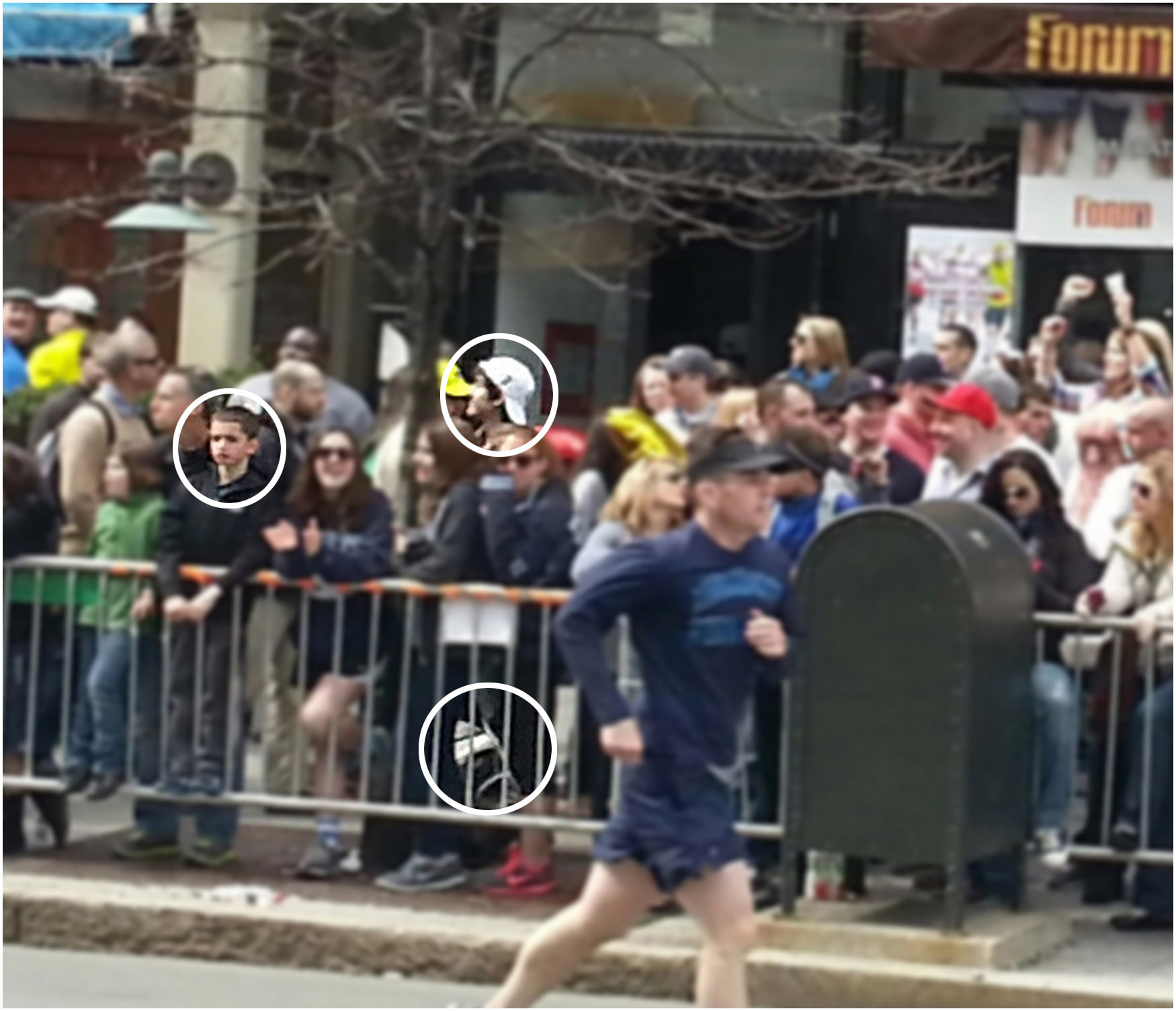 PHOTO: A cell phone image appears to show Boston Marathon bombing suspect #2, Dzhokhar A. Tsarnaev, near a young boy who is standing on the railing and thought to be eight-year-old victim Martin Richard on Boylston Street April 15, 2013 in Boston.
