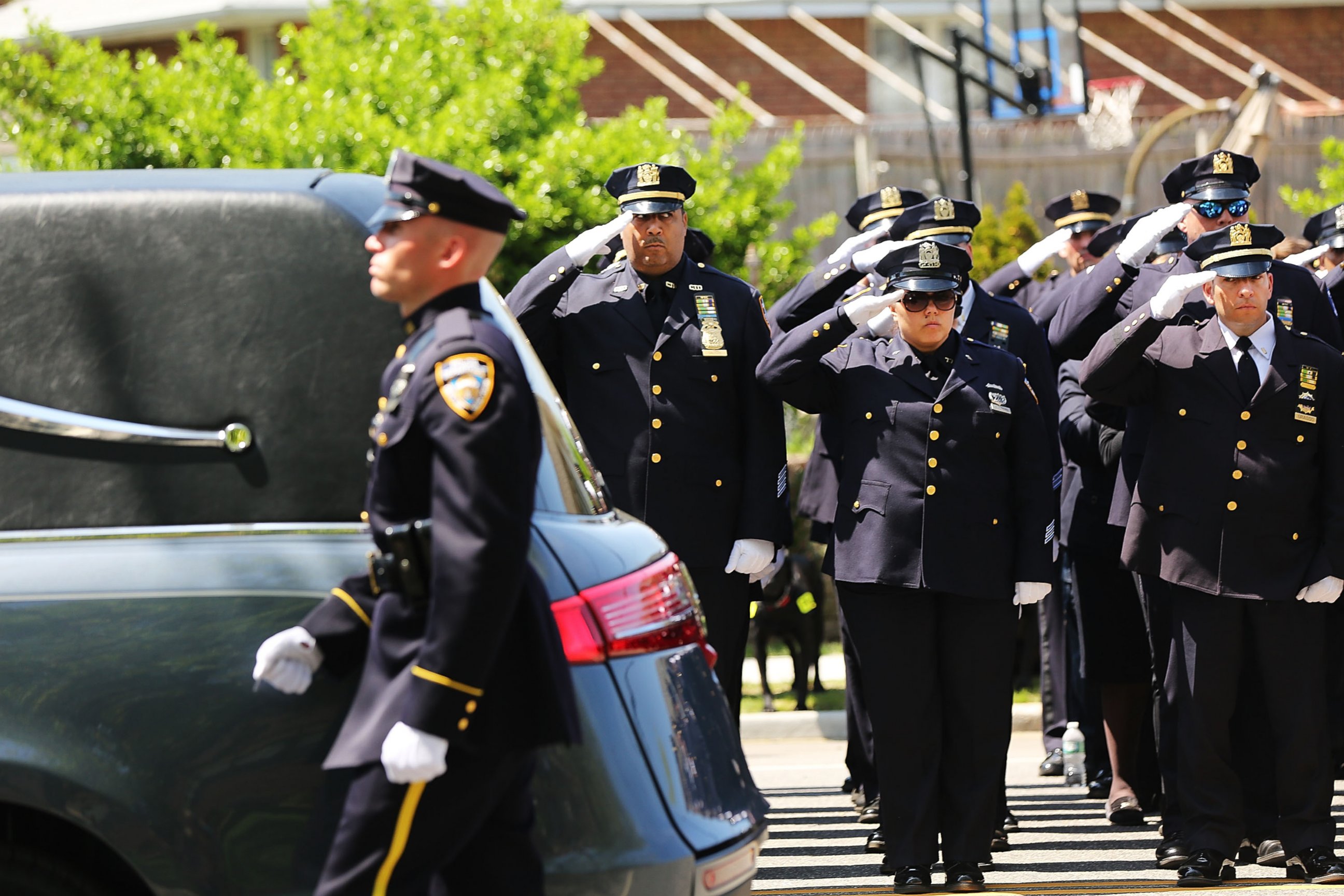 PHOTO: The hearse carrying New York City police officer Brian Moore leaves a Long Island church on May 8, 2015 in Seaford, New York.
