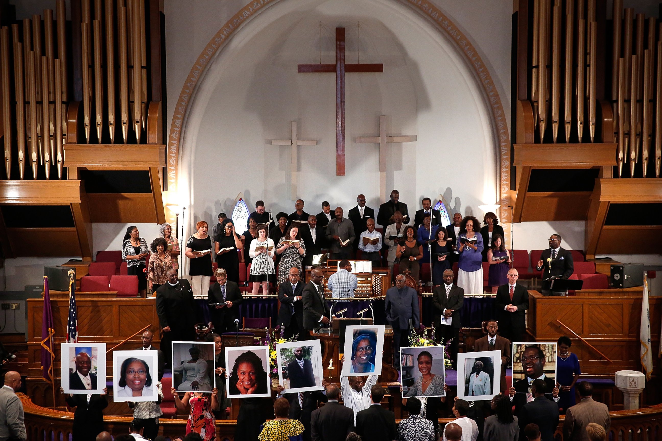 PHOTO: Photographs of the nine victims killed at the Emanuel African Methodist Episcopal Church in Charleston, S.C. are held up by congregants during a prayer vigil at the the Metropolitan AME Church June 19, 2015 in Washington, DC.