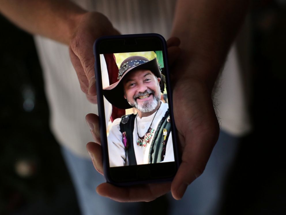 PHOTO: Ryan Reyes, 32, holds a photograph of Daniel Kaufman, right, his boyfriend of three years who was confirmed as one of the victims of Wednesdays mass shooting at the Inland Regional Center.