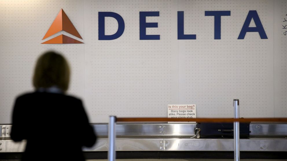 PHOTO: A passenger waits for luggage in the Delta baggage claim.