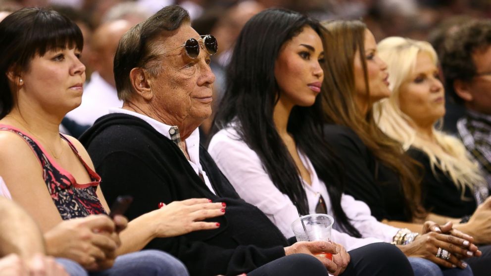 Team owner Donald Sterling of the Los Angeles Clippers and V. Stiviano watch the San Antonio Spurs play  on May 19, 2013 in San Antonio, Texas.  