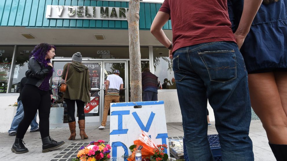 PHOTO: People stop at a makeshift memorial in front of Isla Vista Deli Mart, one of the locations of a killing spree by Elliot Rodger in Isla Vista, Calif. on May 24, 2014.