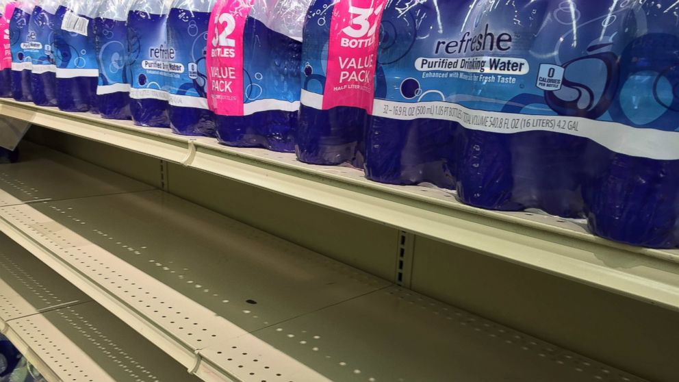 Half empty shelves of water are seen at Safeway in Bowie, Maryland,  Jan. 20, 2016, as weather forecasts predict an incoming snow blizzard to the area.   