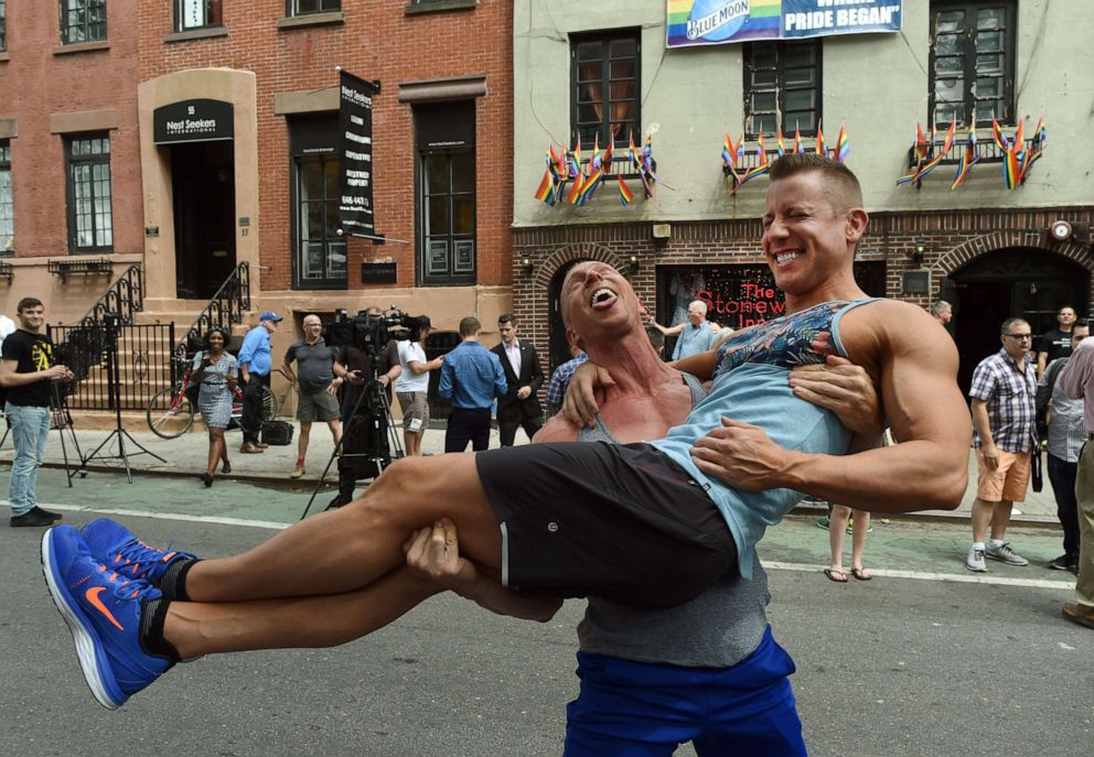 PHOTO: In this June 26, 2015, file photo, Justin Kattler and Tim Loecker from Dallas, Texas celebrate outside the Stonewall Tavern in the West Village in New York.