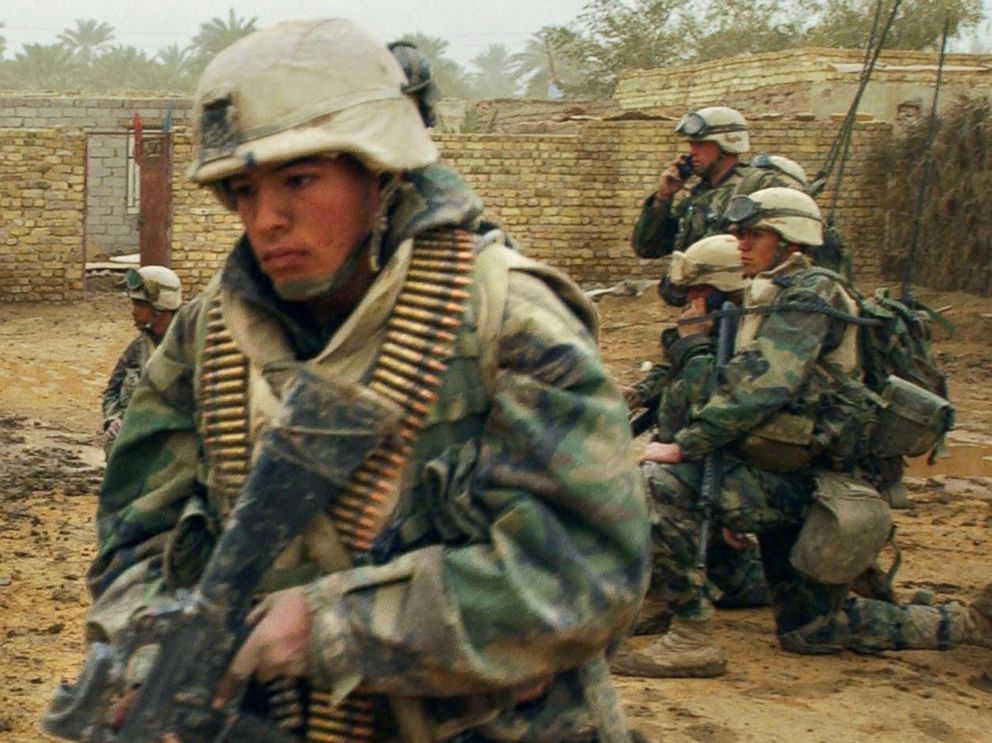 PHOTO: US marines from the 2nd Battalion 8th Regiment take their position in the southern city of Nasiriyah, Iraq, March 26, 2003, during an evacuation of the population living in the area where there was an Iraqi attack the day before. 