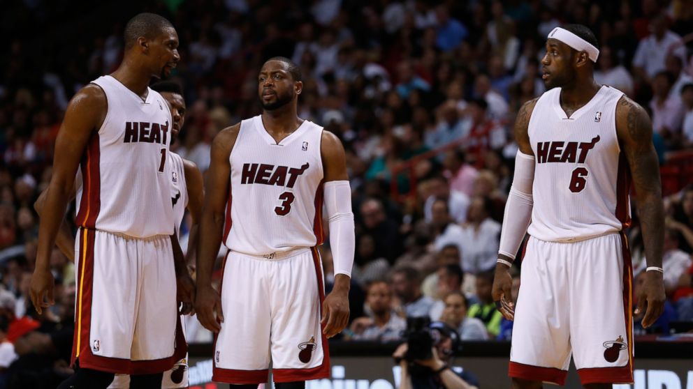 PHOTO: Chris Bosh, Dwyane Wade, and LeBron James of the Miami Heat look on during a game against the Houston Rockets at American Airlines Arena on March 16, 2014 in Miami. 