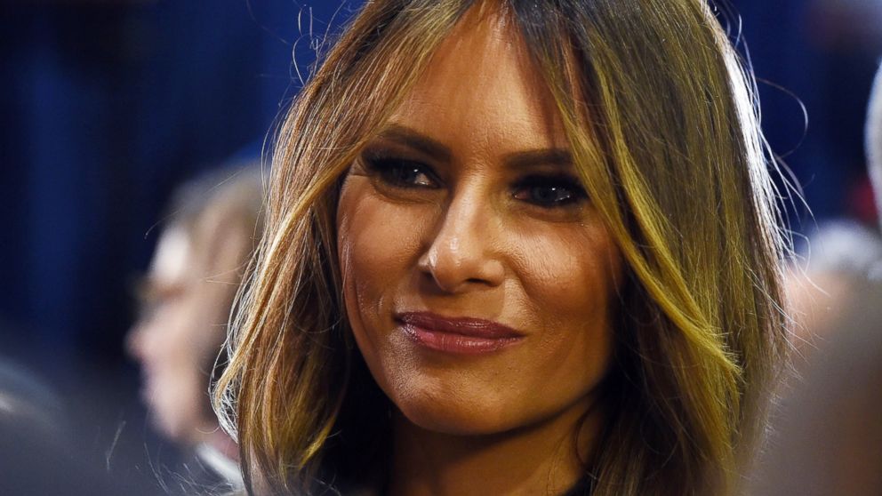 Melania Trump looks on as Donald Trump talks to reporters in the spin room following a presidential debate on Dec. 15, 2015 in Las Vegas.