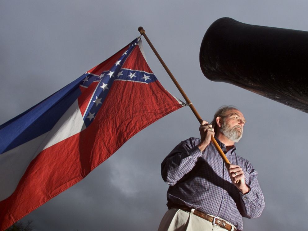 PHOTO: In this file photo taken on Dec. 12, 2001, Harry Sharp proudly holds the Mississippi State flag in the centre of Vicksberg Miss.