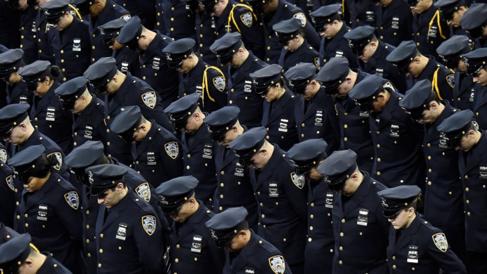 Cadets bow their heads during the New York Police Department graduation ceremony at Madison Square Garden on Dec. 29, 2014 in New York City. 