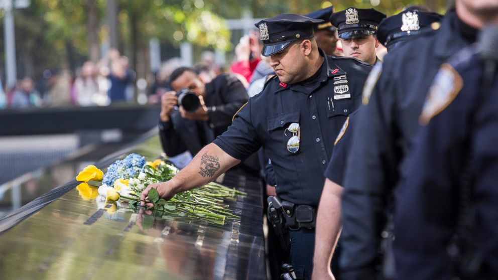 Law enforcement officials lay flowers in tribute to slain New York Police Department officer Randolph Holder at National September 11th Memorial on Oct. 22, 2015 in New York City.  