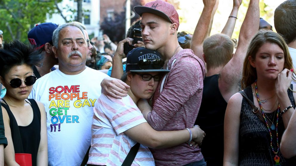 PHOTO: People gather outside of the Stonewall Inn in New York during a vigil for the victims of a massacre at a gay nightclub in Orlando, June 12, 2016.