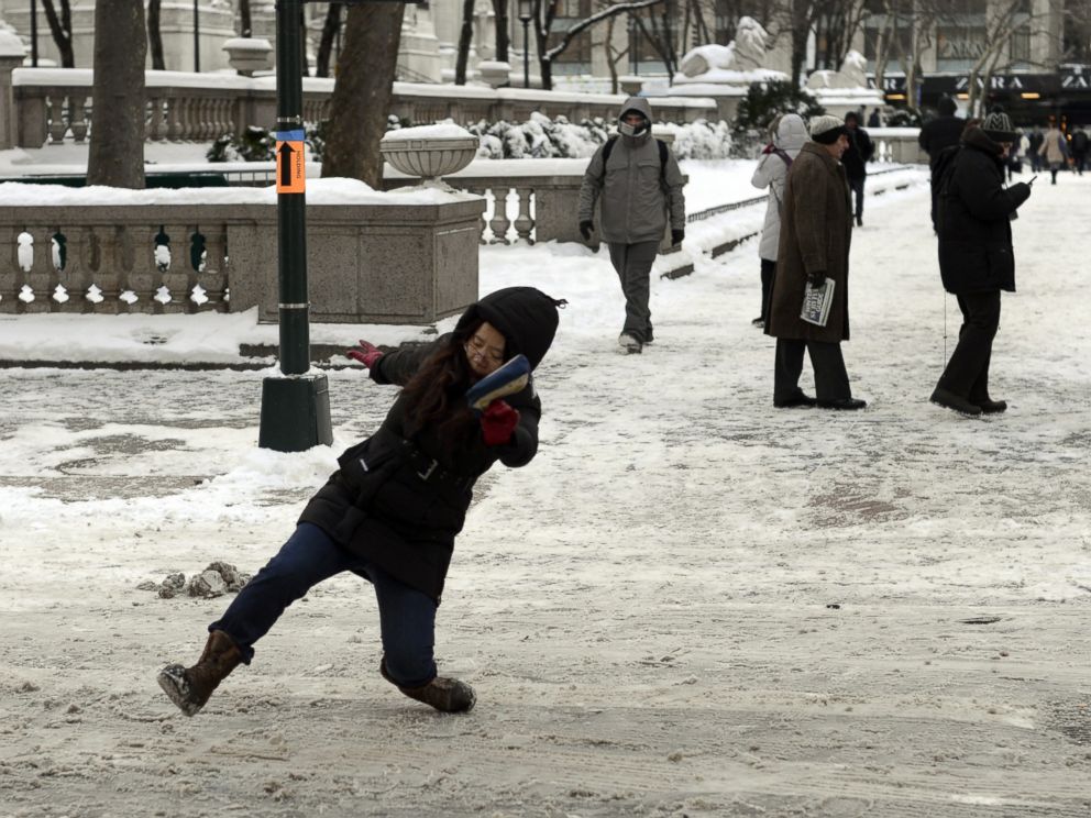 PHOTO: A woman falls on the ice and snow along 5th Avenue on Jan. 22, 2014 in New York.