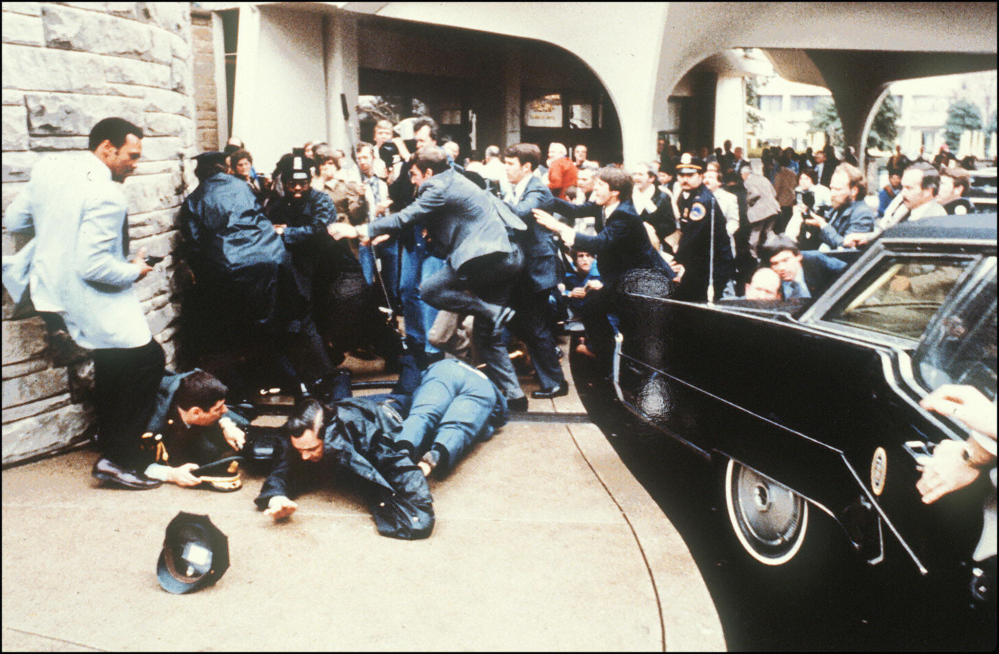 PHOTO: Police and Secret Service agent react during the assassination attempt on President Ronald Reagan on March 30, 1981 outside the Hilton Hotel in Washington, D.C.