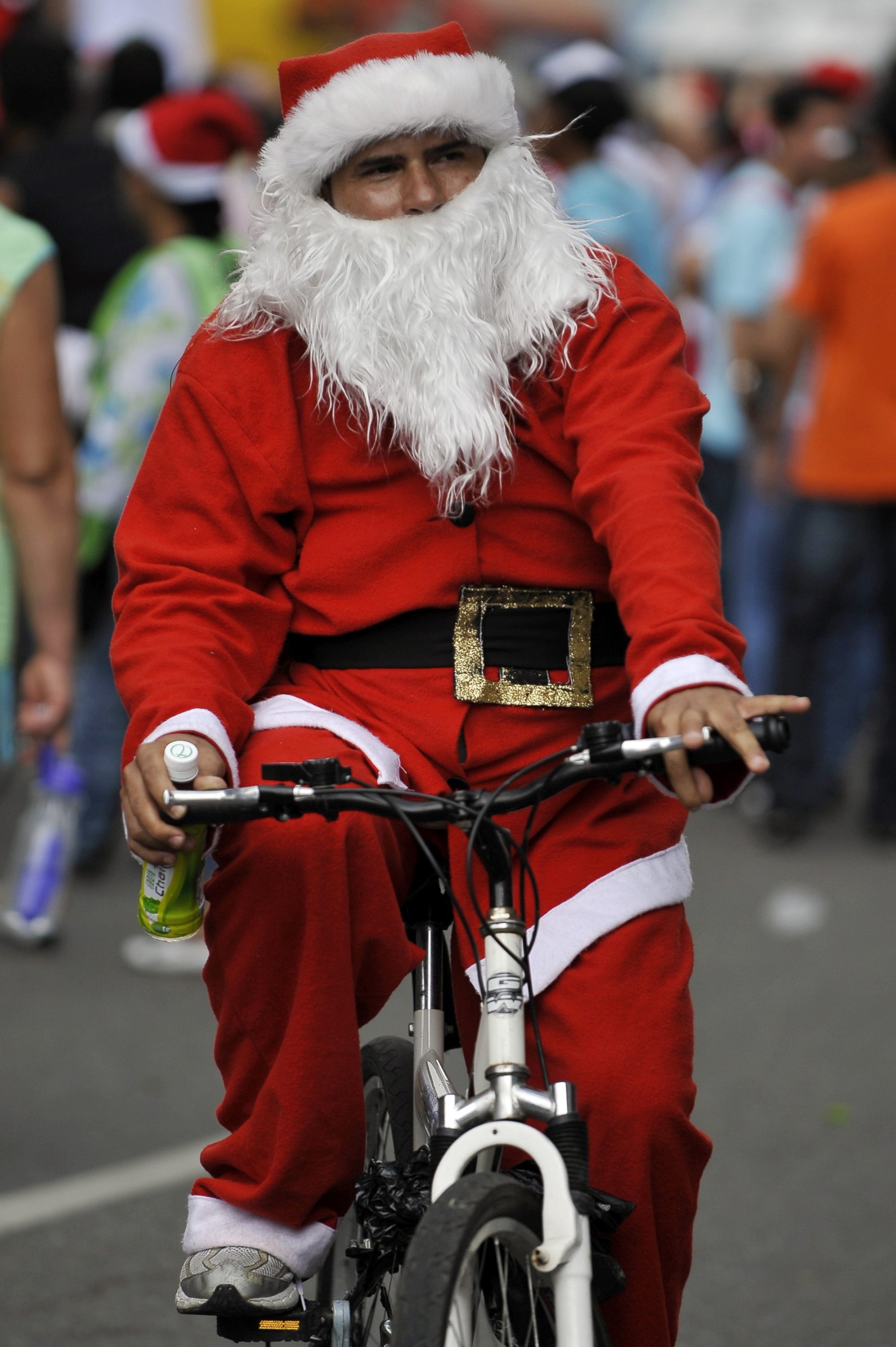 PHOTO: A man dressed as Santa Claus rides his bicycle with other hundreds along the streets of Cali, Colombia, on December 12, 2010 in a failed attempt to break the previous Guinness record of 12,000 people riding bikes dressed as Santa Claus. 