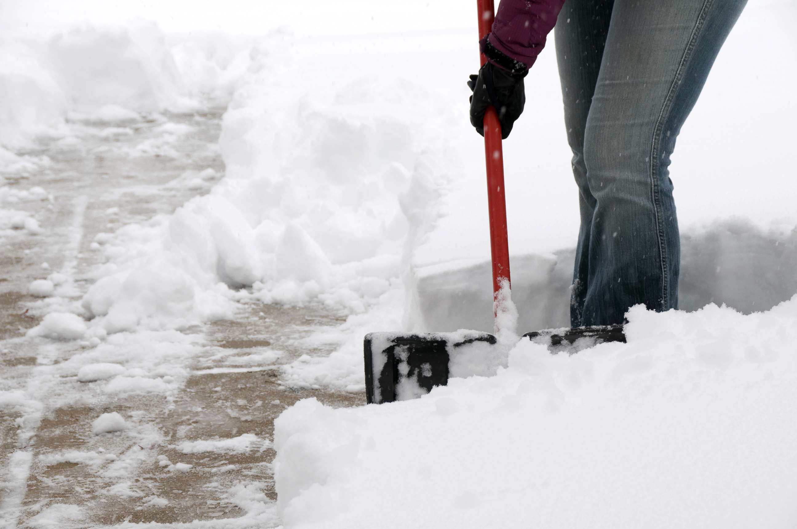 PHOTO: A person shovels snow.