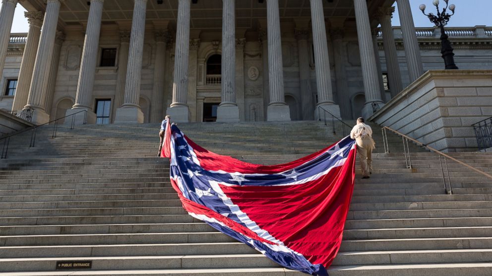 PHOTO: Confederate re-enactors position a gigantic Confederate flag on the steps of the South Carolina State Capitol building on May 2, 2015 in Columbia, SC. 