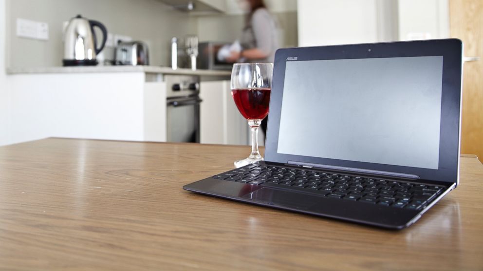 PHOTO: A laptop on a kitchen table with a glass of red wine, in this stock photo taken on July 23, 2012. 