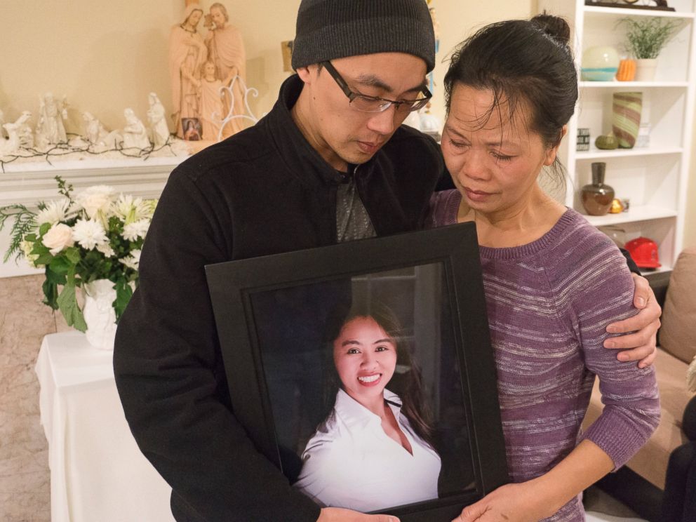 PHOTO:Vanessa Nguyen, the mother, and Trung Do, the brother, hold a photograph of Tin Nguyen who was one victims who died in the shootings in San Bernardino on Wednesday on display at her Santa Ana home, Dec. 3, 2015. 