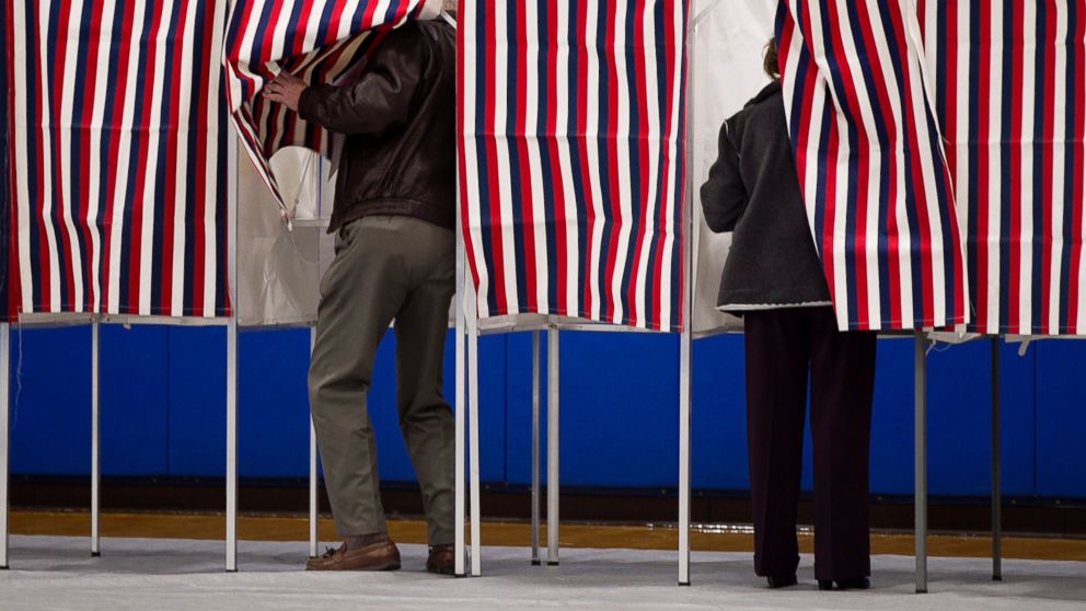 PHOTO: Two voters enter their booths to vote at Londonderry High School for the Republican New Hampshire primary election, Jan. 10, 2012 file photo.
