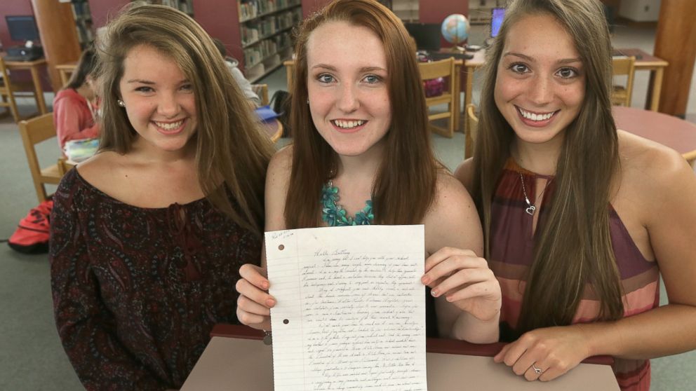 Three Massachusetts high school students, Mollykate Rodenbush, Brittany Tainsh, and Michaela Arguin are pictured with a handwritten letter from Whitey Bulger, June 19, 2015.