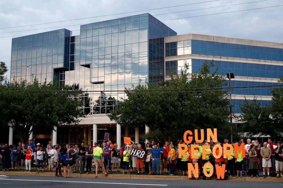 PHOTO: FILE - In this Aug. 5, 2019, file photo, people gather at a vigil for recent victims of gun violence outside the National Rifle Association's headquarters building in Fairfax, Va. 