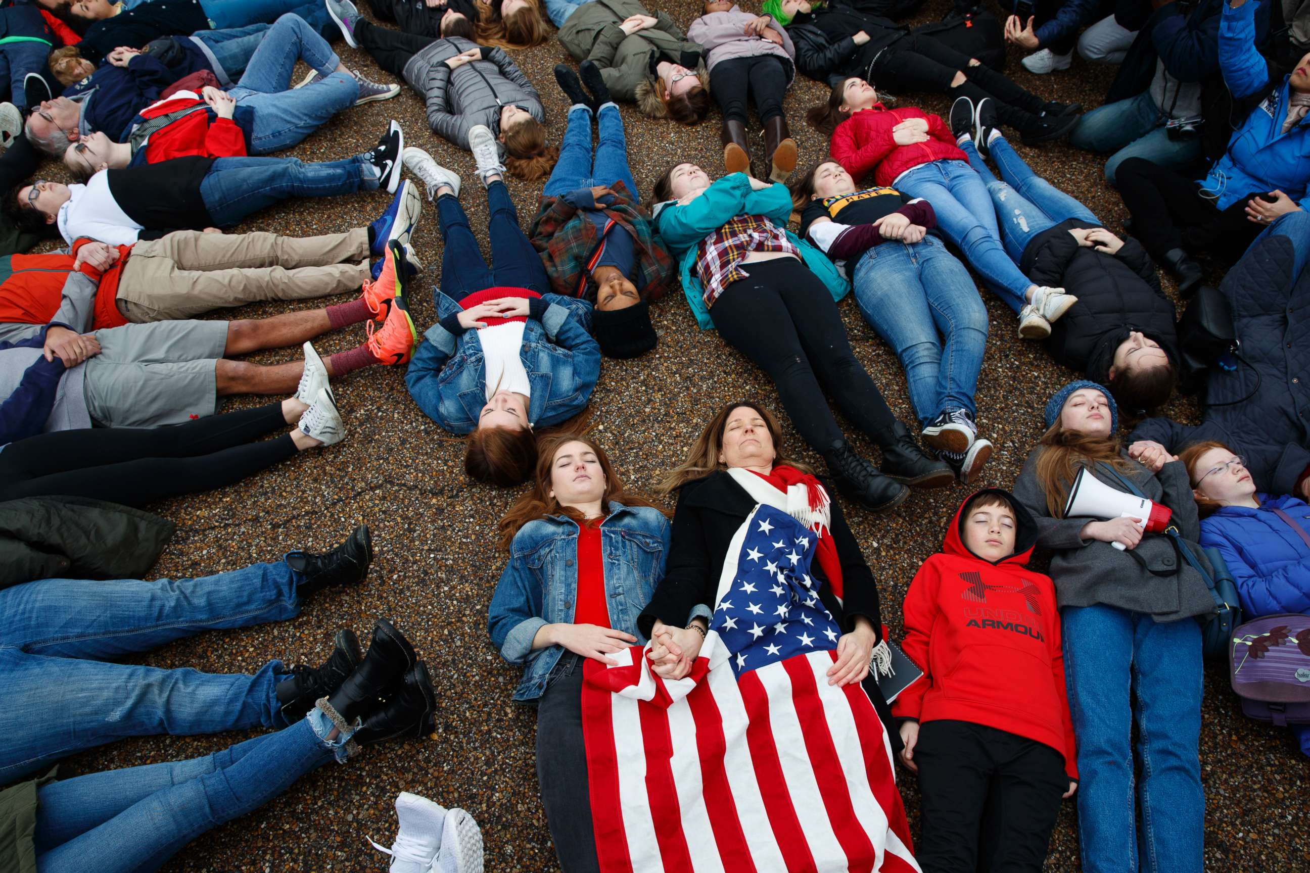 PHOTO: Abby Spangler and her daughter Eleanor Spangler Neuchterlein, 16, hold hands as they participate in a "lie-in" during a protest in favor of gun control reform in front of the White House in Washington, D.C., Feb. 19, 2018.