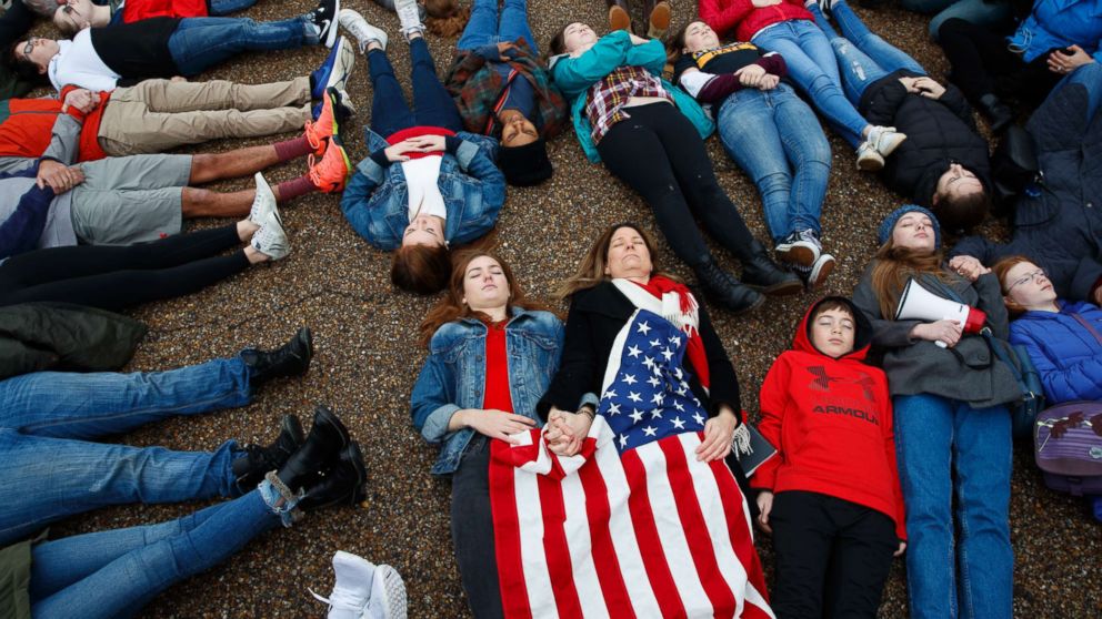 PHOTO: Abby Spangler and her daughter Eleanor Spangler Neuchterlein, 16, hold hands as they participate in a "lie-in" during a protest in favor of gun control reform in front of the White House in Washington, D.C., Feb. 19, 2018.
