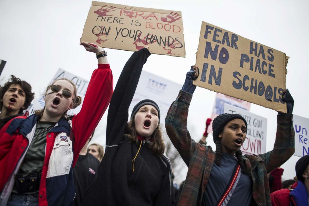 PHOTO: Demonstrators hold signs during a "lie-in" demonstration supporting gun control reform near the White House, Feb. 19, 2018, in Washington, D.C.