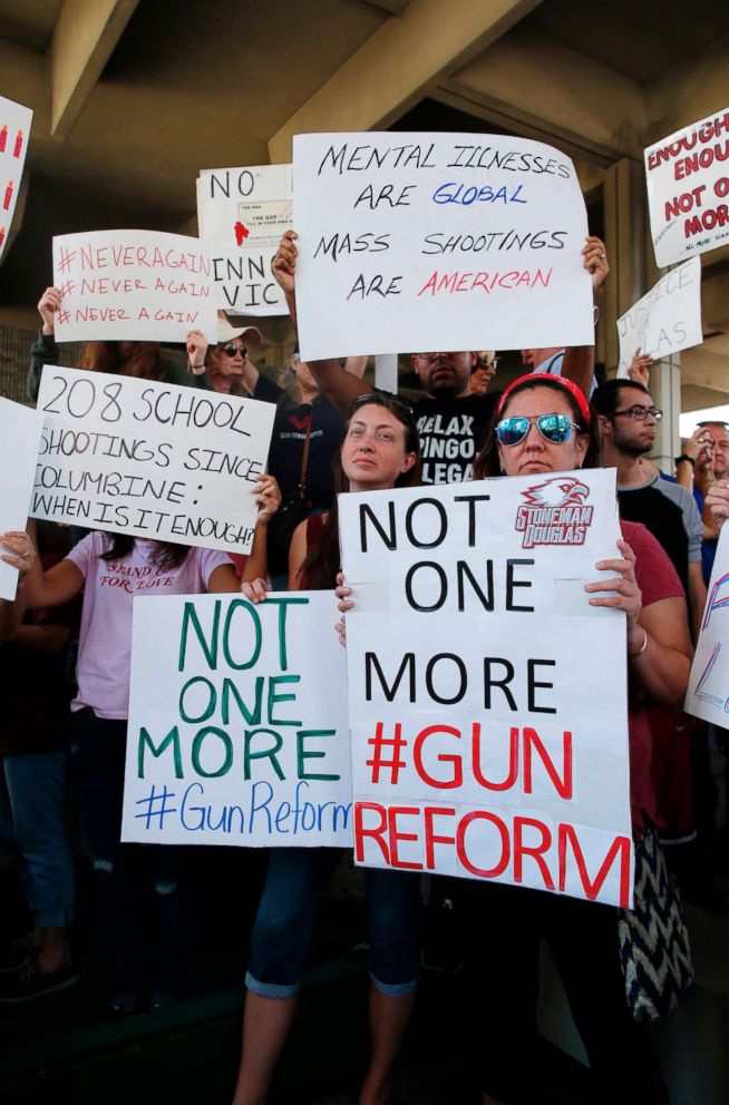 PHOTO: Protesters hold signs at a rally for gun control at the Broward County Federal Courthouse in Fort Lauderdale, Fla., Feb. 17, 2018.