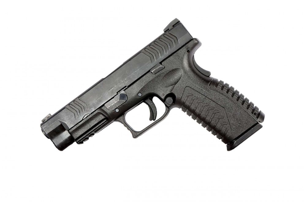 PHOTO: A close-up view of a semi-automatic 9mm handgun on a white background.