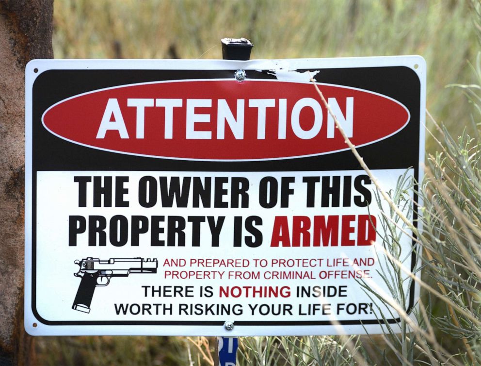 PHOTO: A warning sign sits posted in the front yard of a gun owner in Santa Fe, N.M., Aug. 8, 2020.