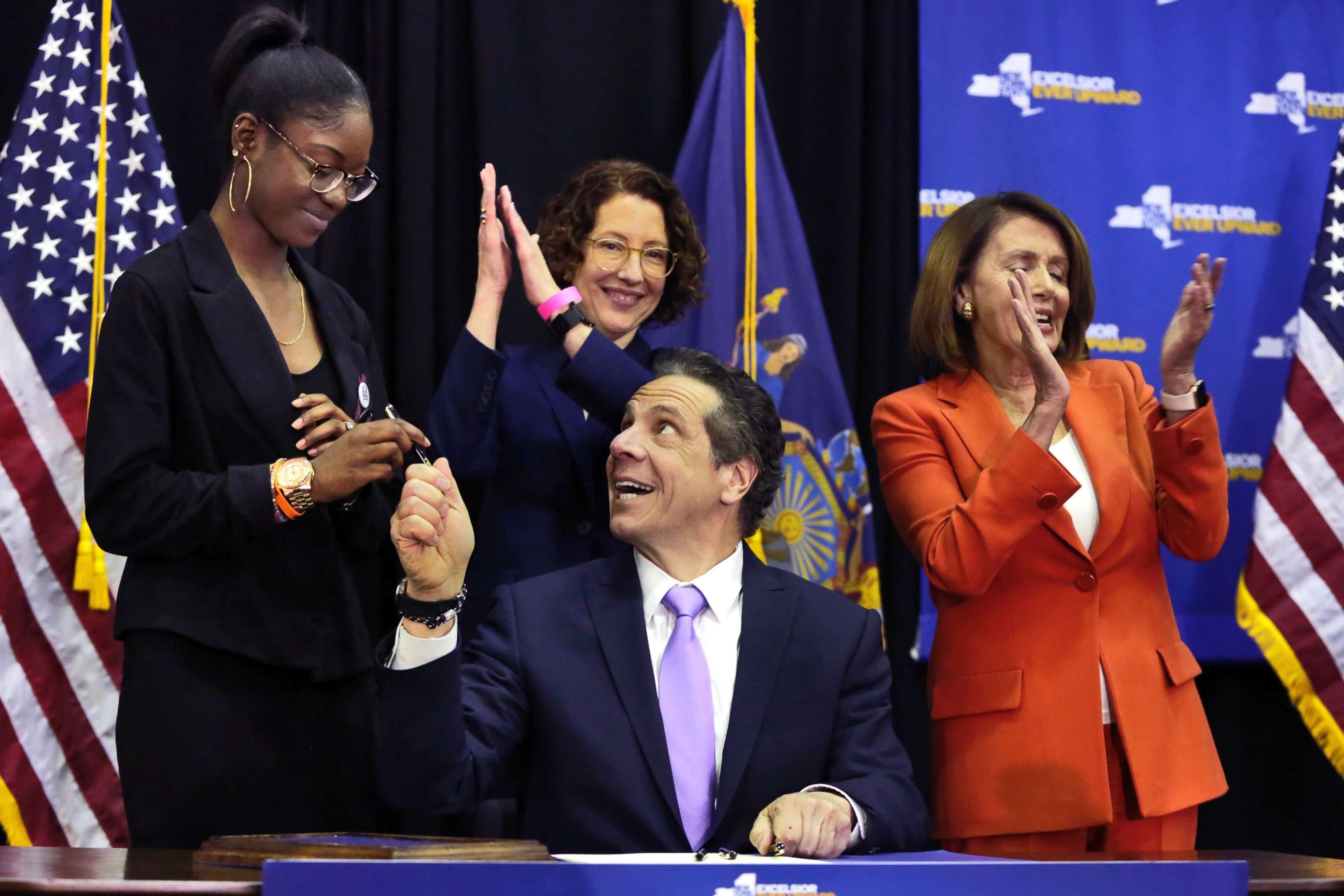 PHOTO: New York Gov. Andrew Cuomo hands a pen to Marjory Stoneman Douglas High School student Aalayah Eastmond, left, as he signs a bill at John Jay College of Criminal Justice, that removes guns from domestic abusers, May 1, 2018, in New York. 