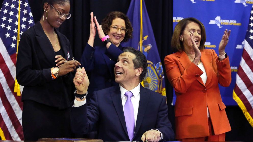 PHOTO: New York Gov. Andrew Cuomo hands a pen to Marjory Stoneman Douglas High School student Aalayah Eastmond, left, as he signs a bill at John Jay College of Criminal Justice, that removes guns from domestic abusers, May 1, 2018, in New York. 