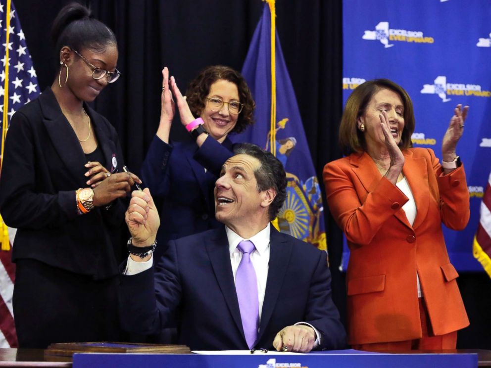 PHOTO: New York Gov. Andrew Cuomo hands a pen to Marjory Stoneman Douglas High School student Aalayah Eastmond, left, as he signs a bill at John Jay College of Criminal Justice, that removes guns from domestic abusers, May 1, 2018, in New York.