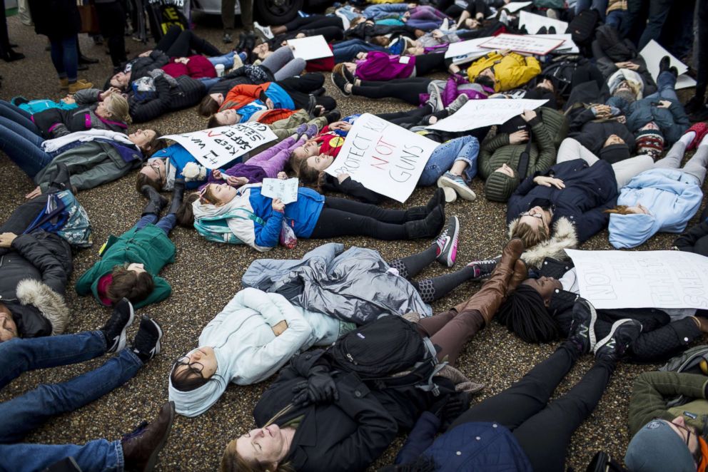 PHOTO: Demonstrators lie on the ground during a "lie-in" demonstration supporting gun control reform near the White House on Feb. 19, 2018.