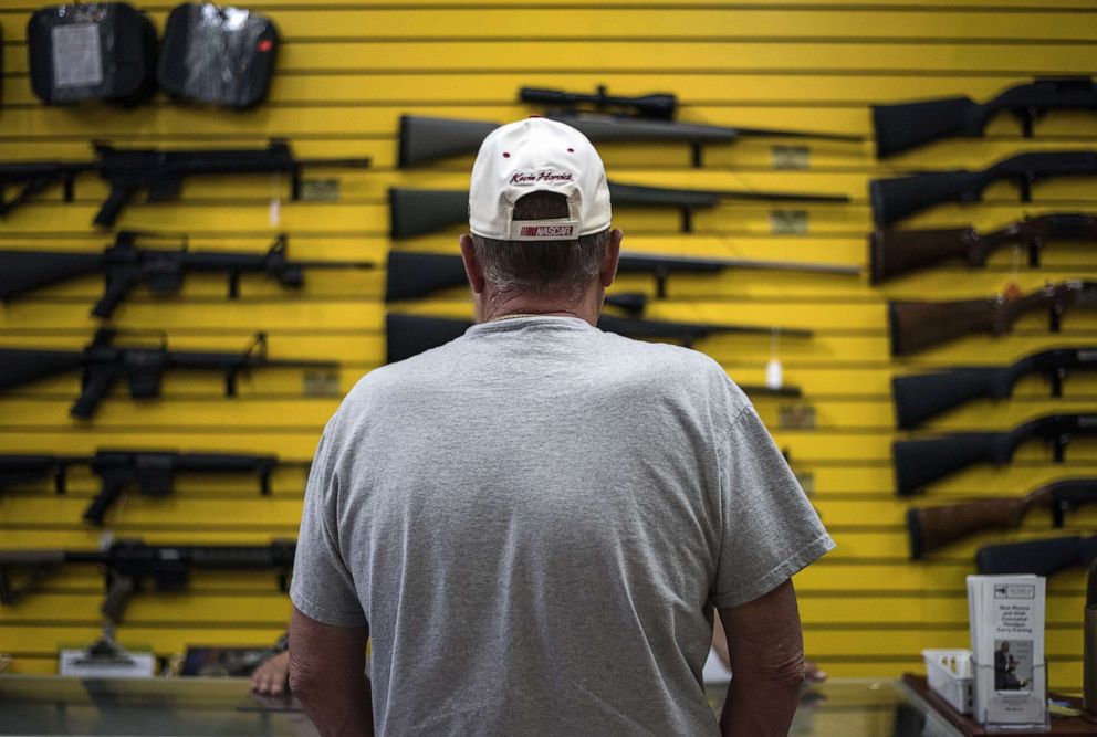 PHOTO: A customer speaks with one of the owners at a gun shop Albuquerque, N.M., Sept. 1, 2016.